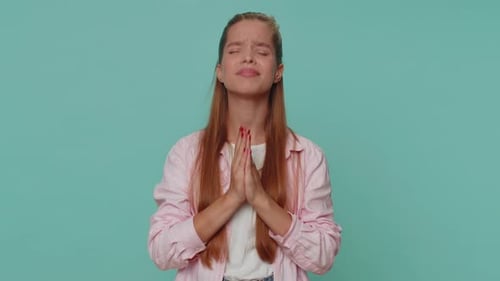 Young Woman Pleading and Praying Indoors