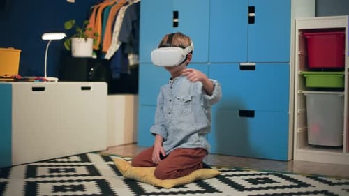 Boy Playing with Virtual Reality Headset Indoors