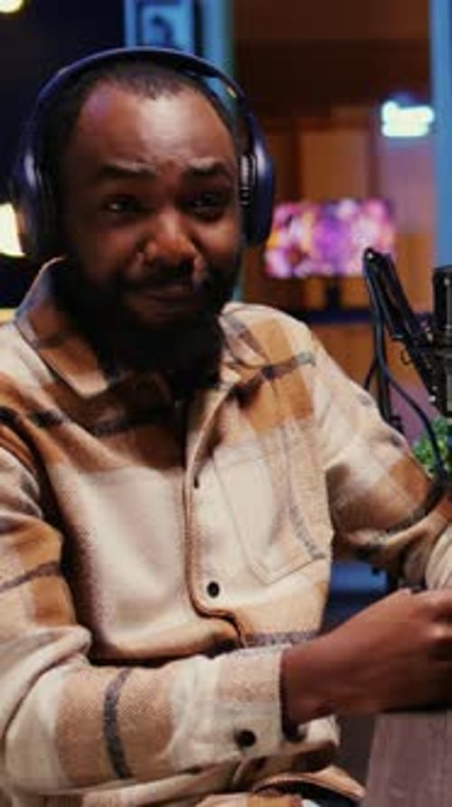 Vertical Video Zoom in on Man on Podcast Discussing with Guest During Marathon Stream