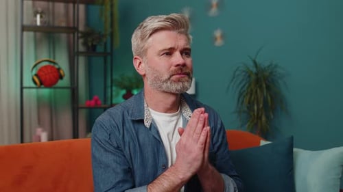 Worried Man Clasped Hands Anticipates Good News