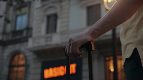 Tourist with Suitcase Baggage in Spain A Traveler with Luggage Strolls Down a Lively City Street to