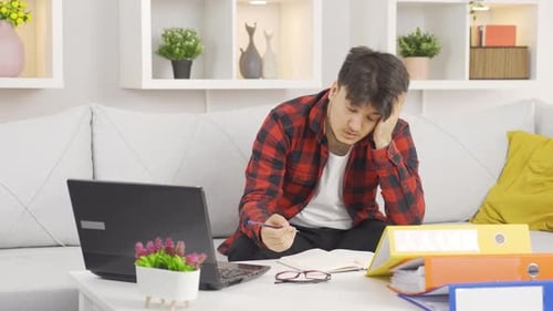 Tired Young Adult Studying at Home