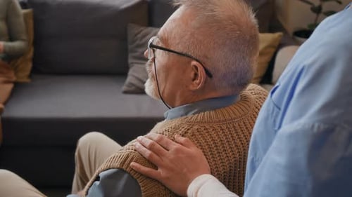 Senior Man with Caregiver in Home Setting