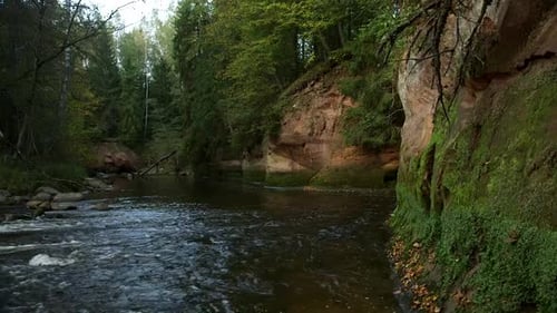 Very Beautiful Rocky River Landscape with Red Rock Outcrops and Small Rapids