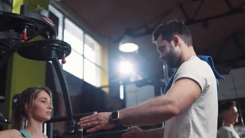 Attractive Woman Doing Exercises with a Personal Trainer in the Gym Sport Fitness Workout Athlete