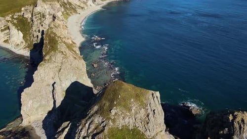 Aerial Breathtaking View of the Sunny Cape with High Cliffs