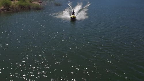 Aerial Drone of Man Riding Personal Water Craft on Lake