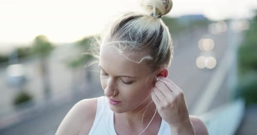 Earphones, sports and young woman in city preparing for cardio race, competition