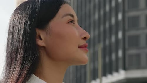 Young Woman Opens Her Eyes and Joyfully Looks Upwards with a Smile