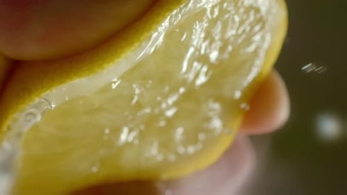 A Person Squeeze a Lemon Until Juice Comes Out
