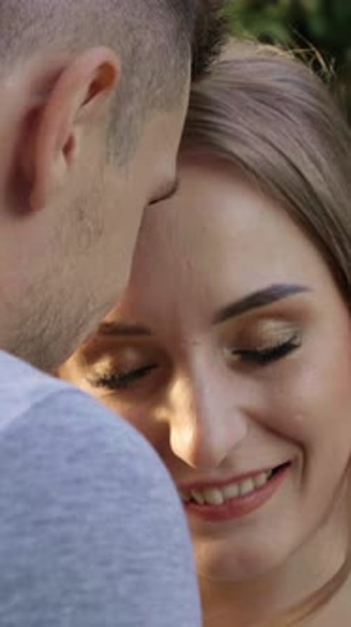 Young Couple Smiling and Embracing in Nature