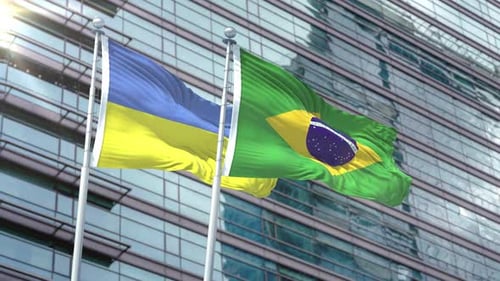 Waving Flags of Ukraine and Brazil on Modern Corporate Building