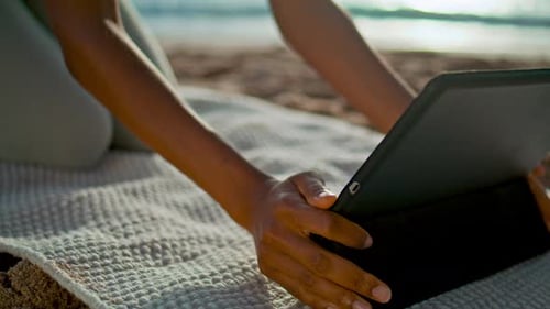 Girl Using Tablet on Beach Yoga Mat