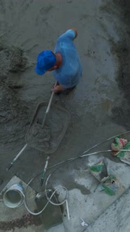 Vertical Video Concrete Action Aerial View of a Builder Filling a Trolley and Casting Concrete Onto