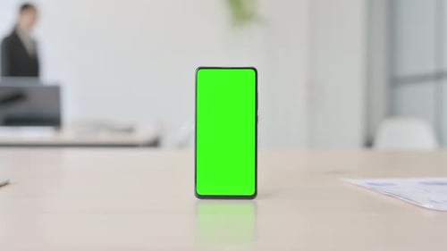 Smartphone with Green Screen on Table