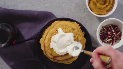 Adding Toppings to Pumpkin Pancakes for Fall