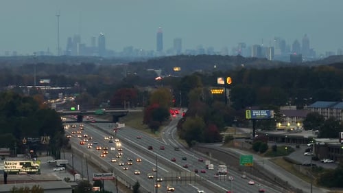 American Freeway with Fast Driving Cars and Trucks and Highrise Skyscrapers of Atlanta City in