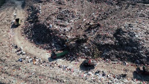 Large Waste Dump and Trash Truck with Garbage in Aerial Top View