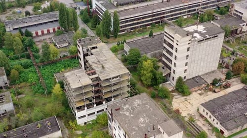 View from above of ruined and abandoned factory. Aerial view of industrial destroyed city buildings.