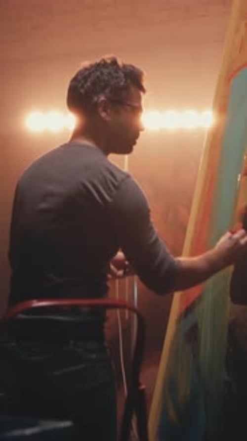 Man Painting on Large Canvas in Art Studio