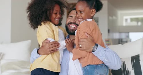 Loving Father Embraced by Daughters at Home