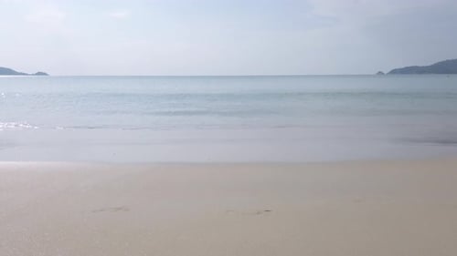 Summer video 4k of the beach with some waves in sunshine daytime with white sand beach and clear blu