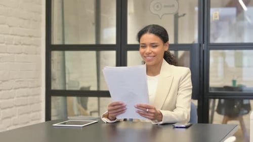 Professional Woman Reading Good News in Modern Office