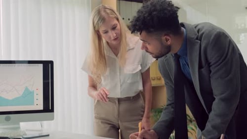 Financial Managers Evaluating Risks of Deal Using Chart on Screen