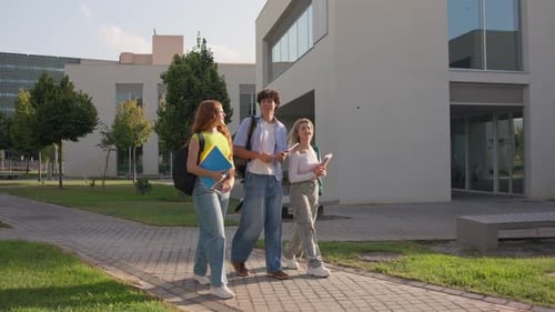 University Students Walking and Talking on Campus Pathway