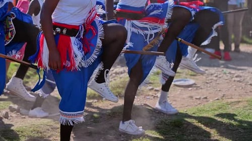 Group Performs Synchronized Dance with Sticks Outdoors