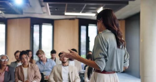 Woman Giving Presentation to Audience in Conference Room