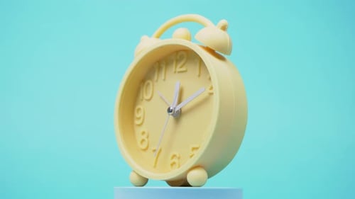 Yellow Alarm Clock on Blue Background Slowly Rotating