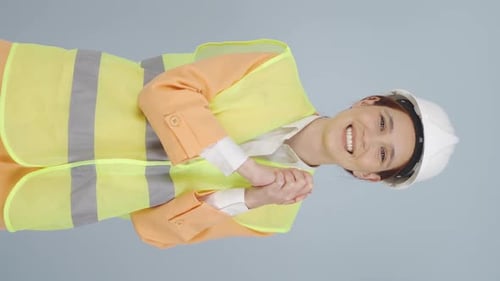 Vertical video of Engineer making a sign of confidence at the camera.