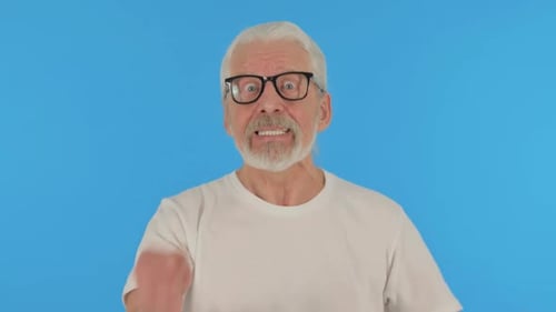 Angry Casual Old Man Talking in Anger on Green Background, Portrait