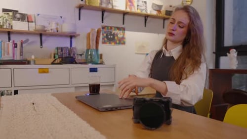 Frustrated Woman Closing Laptop at Wooden Desk Indoors