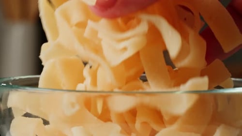 Noodles Falling Into a Bowl