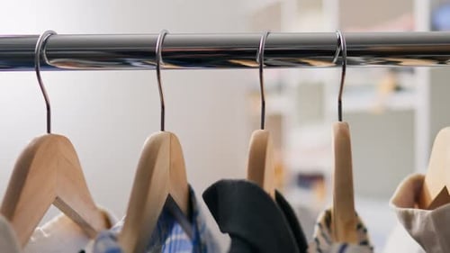 Shirts Hanging in Closet on Wooden Hangers