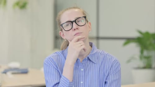 Woman Thinking with Hand on Chin in Office