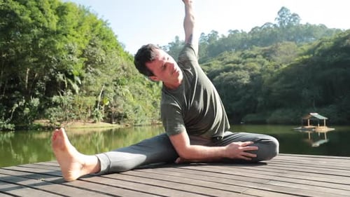 Man stretching in yoga pose outdoors
