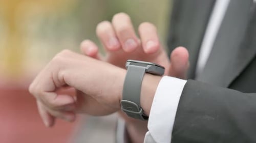 Close up of Businessman using Smart Watch Outdoor