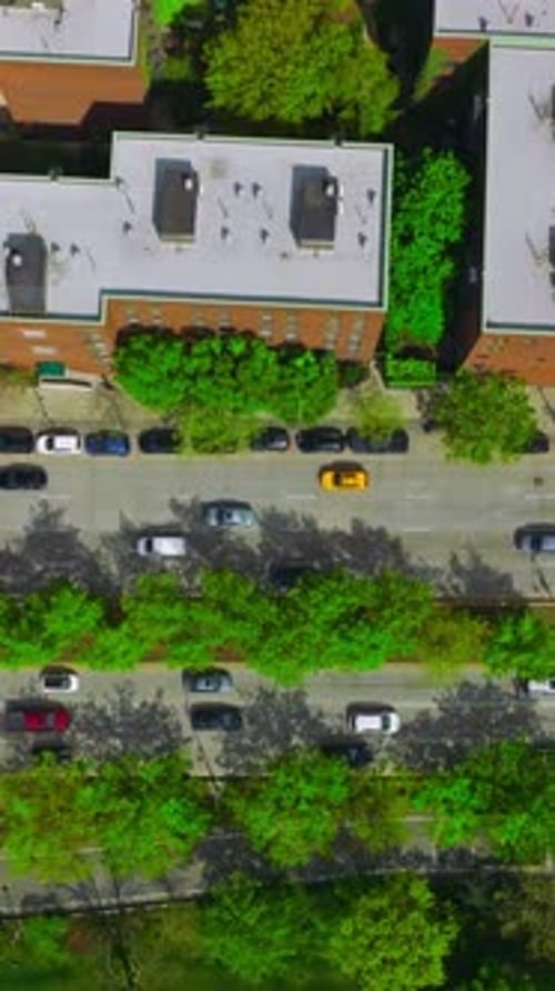 Cars driving quickly over the roads of busy city. New York city traffic. Aerial perspective.