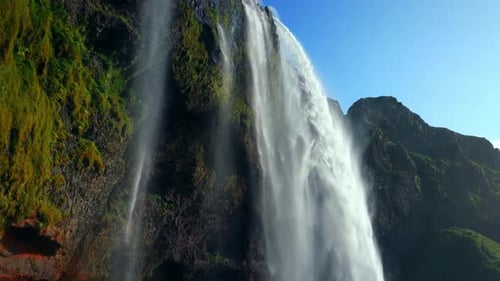 Famous Waterfall Of Seljalandsfoss In South Region Of Iceland. descending drone shot