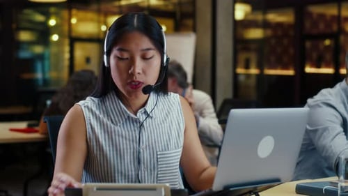 Asian Woman Working in Call Center Office