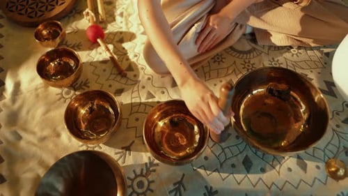 Woman Makes Sound on Tibetan Singing Bowls