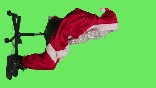 Santa Claus Sitting in Office Chair on Green Screen