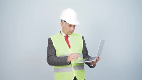 Engineer working on project on laptop.