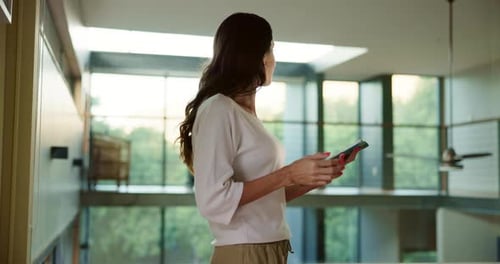 Woman Using Tablet Inside Modern Home