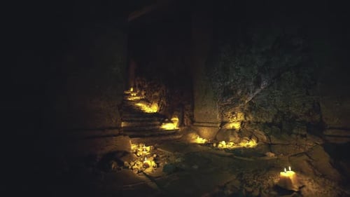 Gloomy Stairway Descends Into Secret Shrine Filled with Candles
