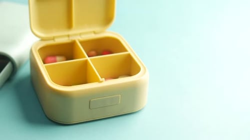 Organizing Daily Medications in a Colorful Pill Box Tool