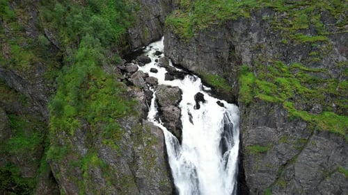 Dramatic Waterfall Cascading Down Rocky Cliff Face
